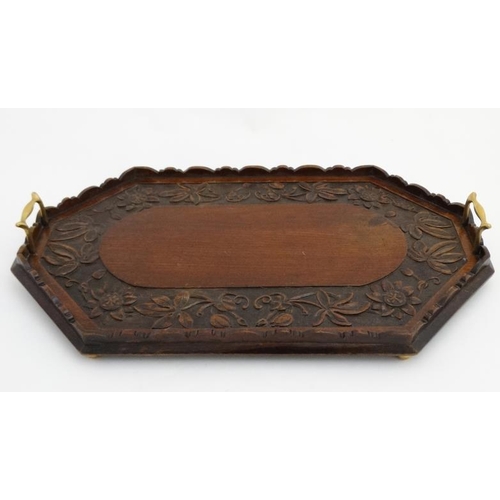 981A - A late 19thC carved mahogany tray with brass handles 24 1/2'' long x 14 1/4'' wide