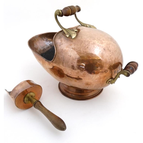 984 - A 19thC copper and brass helmet shaped coal scuttle with integral scoop 20'' long