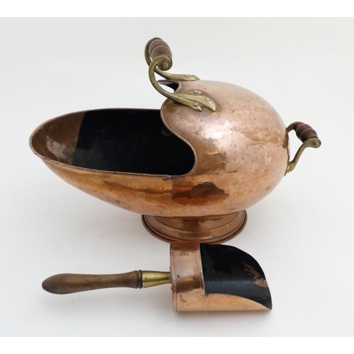 984 - A 19thC copper and brass helmet shaped coal scuttle with integral scoop 20'' long