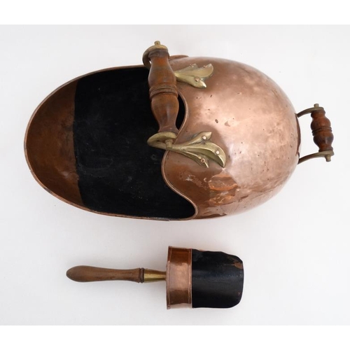 984 - A 19thC copper and brass helmet shaped coal scuttle with integral scoop 20'' long