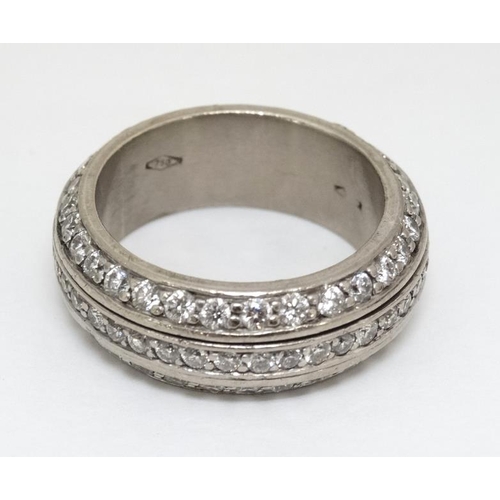 992 - An 18ct white gold large ring set with three bands of diamond , the central band rotating. ( diamond... 