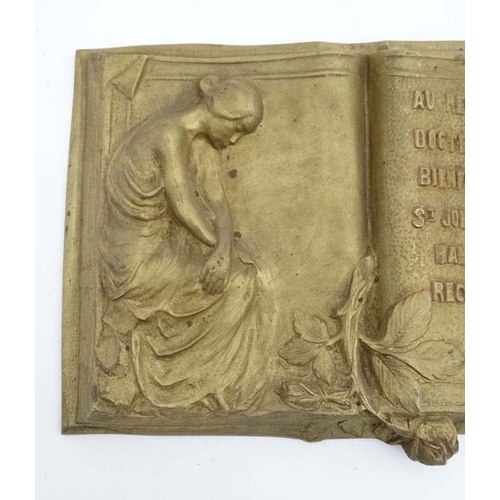 988 - A 19thC gilt painted plaque in the form of an open book in relief stating 'Au Regrette Docteur Schil... 