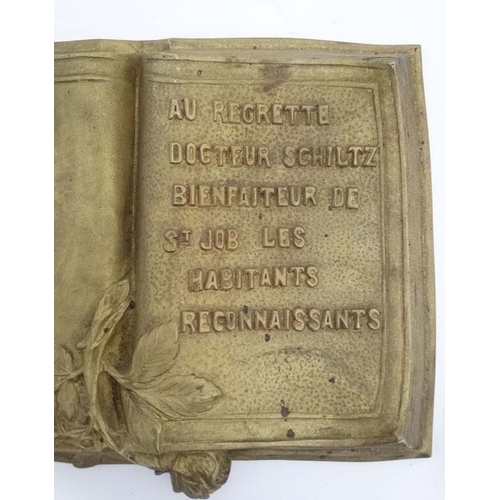 988 - A 19thC gilt painted plaque in the form of an open book in relief stating 'Au Regrette Docteur Schil... 