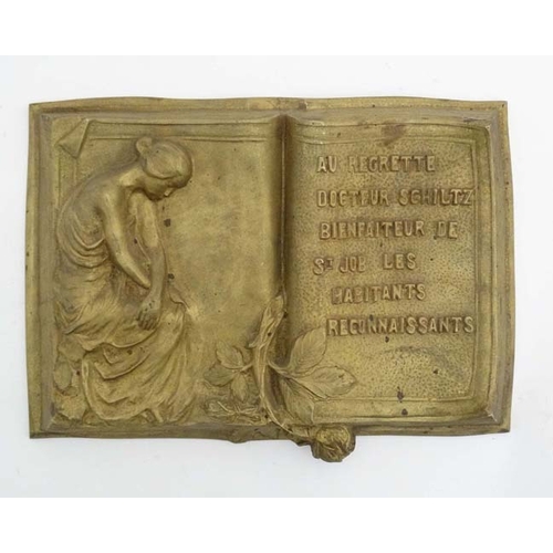 988 - A 19thC gilt painted plaque in the form of an open book in relief stating 'Au Regrette Docteur Schil... 