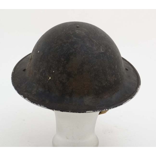 1174 - WWII : An Air Raid Patrol Warden's ' Brodie ' helmet , having blackout finish with interior lining w... 