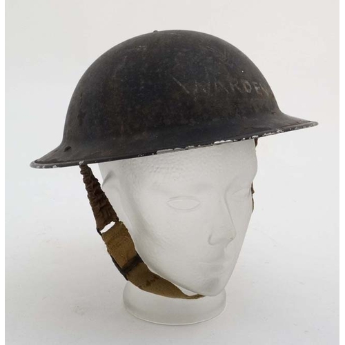 1174 - WWII : An Air Raid Patrol Warden's ' Brodie ' helmet , having blackout finish with interior lining w... 