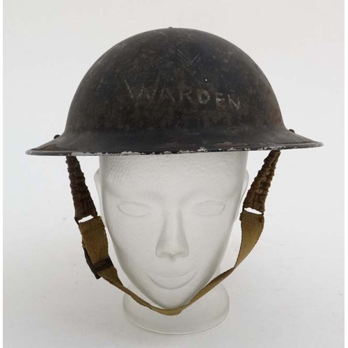 1174 - WWII : An Air Raid Patrol Warden's ' Brodie ' helmet , having blackout finish with interior lining w... 