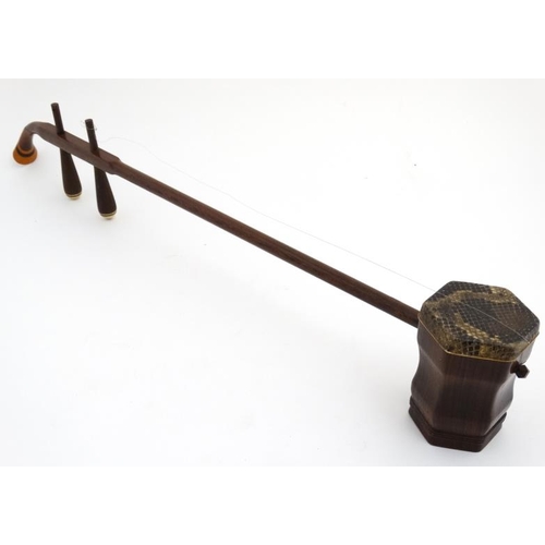 396 - Musical Instruments : An early to mid 20thC Chinese Erhu , ' Chinese Violin ' , the body and neck of... 