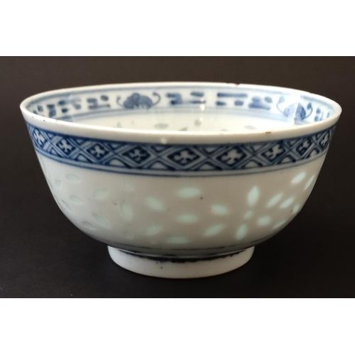 400 - A Chinese blue and white rice bowl, having translucent rice decoration to side and luck symbol to ce... 