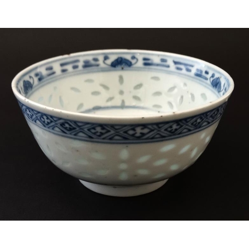 400 - A Chinese blue and white rice bowl, having translucent rice decoration to side and luck symbol to ce... 