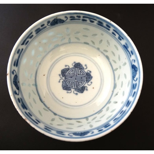 400 - A Chinese blue and white rice bowl, having translucent rice decoration to side and luck symbol to ce... 