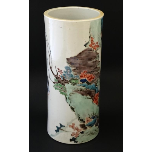 402 - A Chinese famille rose cylinder vase decorated in polychrome with figures fishing in a stream set in... 