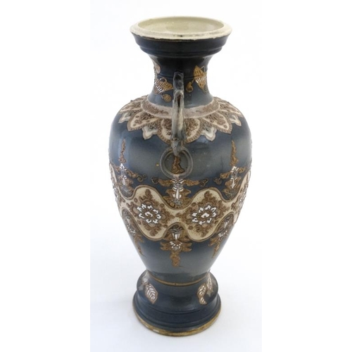 405 - A Chinese two handled lavender blue pedestal vase, having stylised floral detail to body on a cream ... 