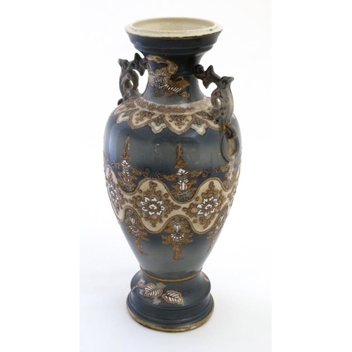 405 - A Chinese two handled lavender blue pedestal vase, having stylised floral detail to body on a cream ... 