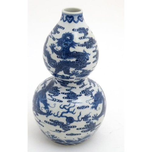 406 - A Chinese blue and white double gourd vase , decorated with 5 clawed dragons and flaming pearls of w... 