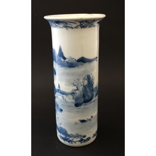 407 - A small Chinese blue and white flared rim cylinder vase, the sides decorated with buildings beside a... 