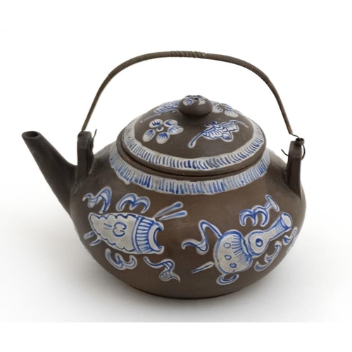 411 - A Chinese Yixing style studio pottery matte brown teapot with lid having blue and white enamel decor... 