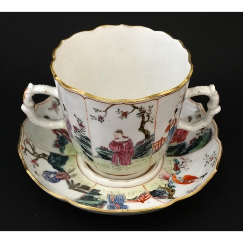 413 - An Oriental famille rose two handled mug and saucer , decorated with panels depicting figures in gar... 