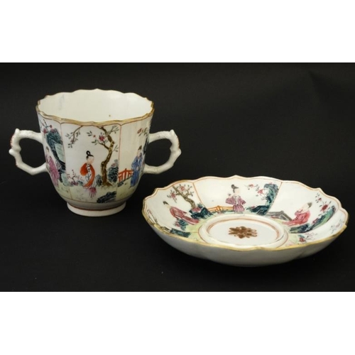 413 - An Oriental famille rose two handled mug and saucer , decorated with panels depicting figures in gar... 