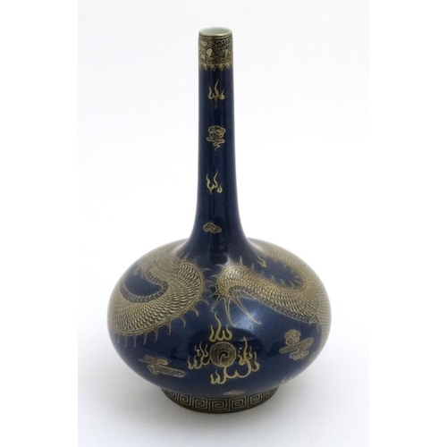 415 - A Chinese bottle vase decorated in gilt with 5 clawed dragon on a powder blue ground, bears red Chin... 