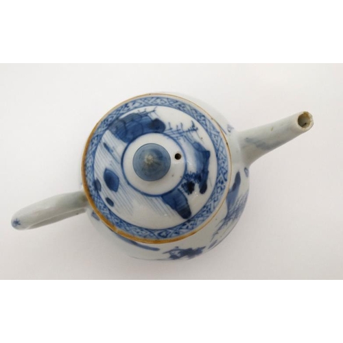 419 - A Chinese blue and white teapot  decorated to sides with figure in a boat fishing on a lake in a mou... 