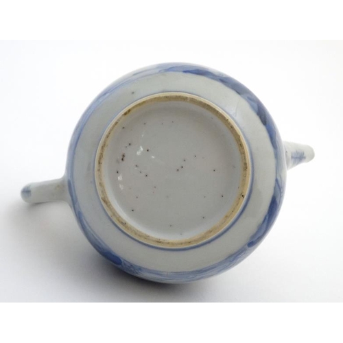 419 - A Chinese blue and white teapot  decorated to sides with figure in a boat fishing on a lake in a mou... 