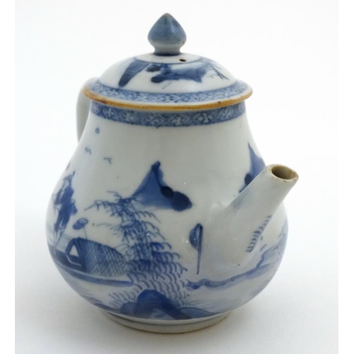 419 - A Chinese blue and white teapot  decorated to sides with figure in a boat fishing on a lake in a mou... 