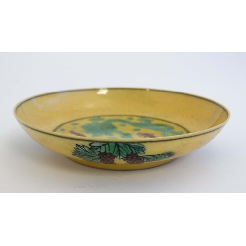 422 - An Imperial yellow  '' dragon '' dish , decorated with two 5 clawed dragons fighting over a flaming ... 