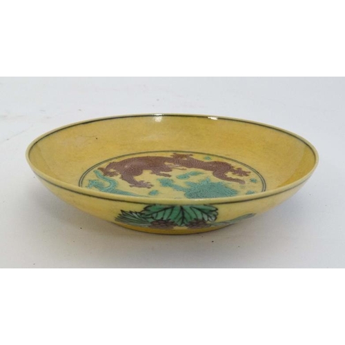 422 - An Imperial yellow  '' dragon '' dish , decorated with two 5 clawed dragons fighting over a flaming ... 