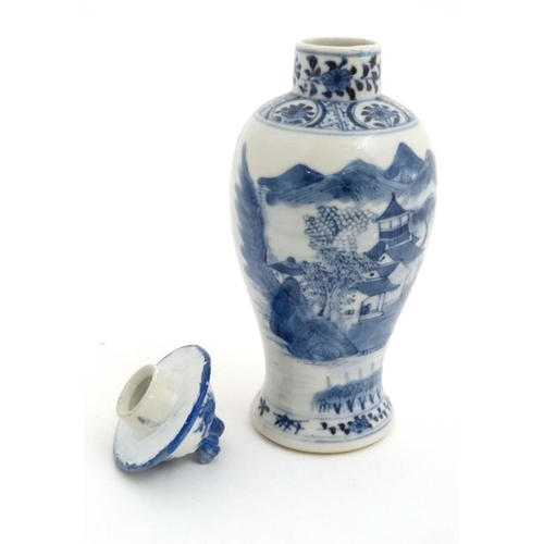 423 - A Chinese blue and white baluster vase and cover, the body decorated with buildings , a bridge and f... 