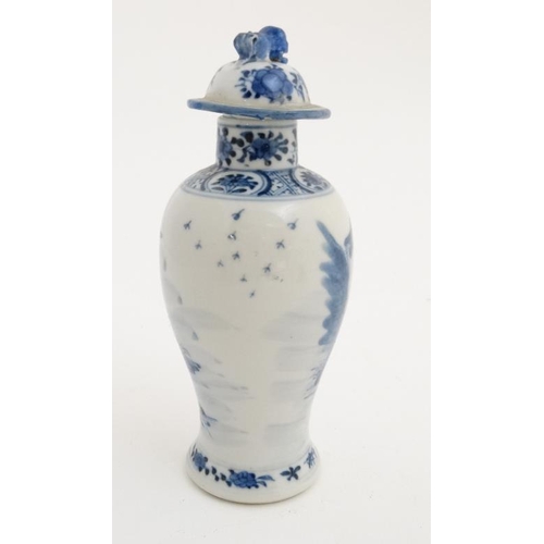 423 - A Chinese blue and white baluster vase and cover, the body decorated with buildings , a bridge and f... 