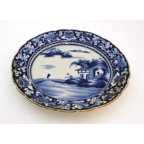 425 - A Chinese blue and white porcelain dish decorated with a figure of a monk crossing the Xiang Xi to a... 