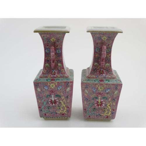 430 - A pair of Chinese twin handled square form vases with flared rims decorated in polychrome enamels wi... 