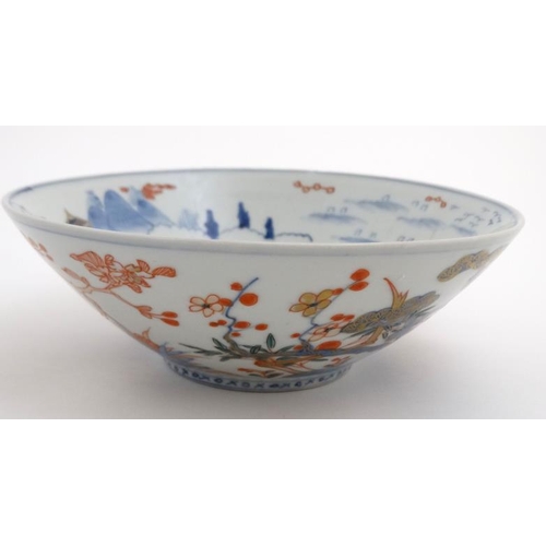 431 - A Japanese Edo style bowl decorated in Imari colours with birds among flowering boughs on rocky outc... 