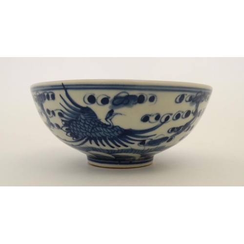 434 - A  Chinese blue and white porcelain bowl. Decorated with oriental birds in flight. Four Chinese char... 