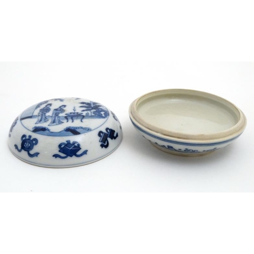 438 - A Chinese blue and white circular ink pot and cover, decorated with female figures in a garden scene... 