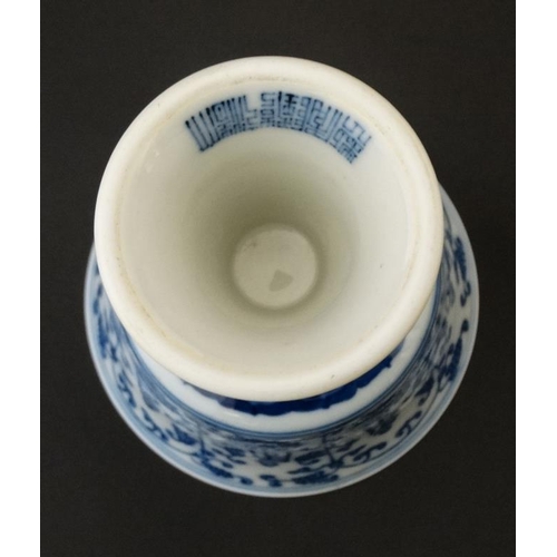 444 - A Chinese blue and white stem cup , the outside decorated with stylised chrysanthemums and character... 