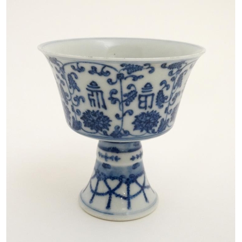 444 - A Chinese blue and white stem cup , the outside decorated with stylised chrysanthemums and character... 