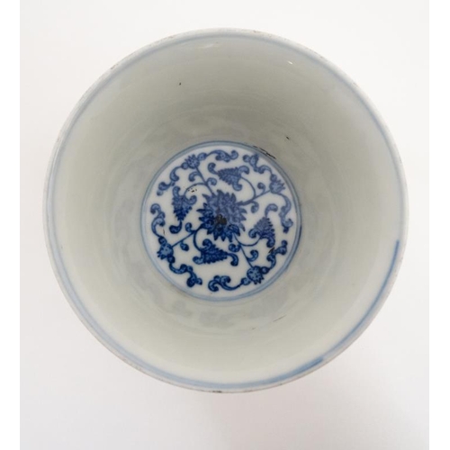 444 - A Chinese blue and white stem cup , the outside decorated with stylised chrysanthemums and character... 