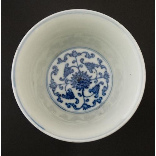 444 - A Chinese blue and white stem cup , the outside decorated with stylised chrysanthemums and character... 