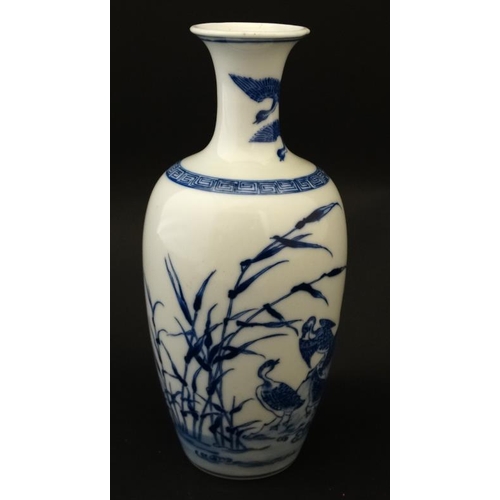 445 - A Chinese blue and white vase with flared rim decorated with ducks amongst reeds, bears blue Chinese... 