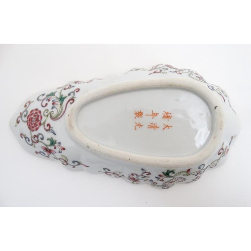 446 - A Chinese dish of shell form decorated to top with red bats, , luck symbols and 5 clawed dragon on a... 