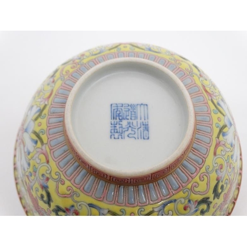 447 - A Chinese bowl , having famille rose chrysanthemum and goldfish decoration to exterior on a yellow g... 