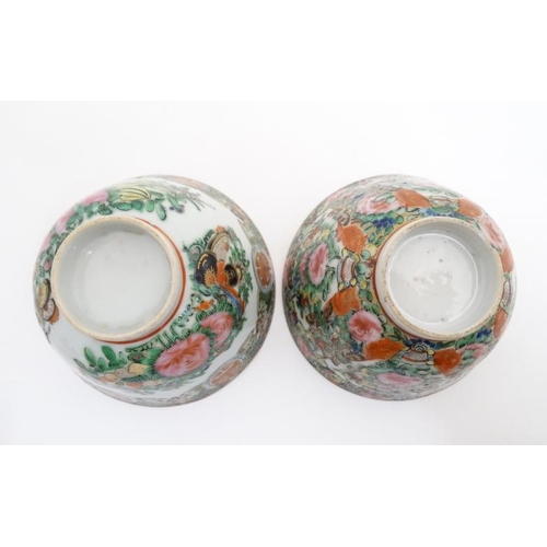 448 - A pair of Canton enamel painted bowls, one decorated with shou characters and peaches, the other wit... 