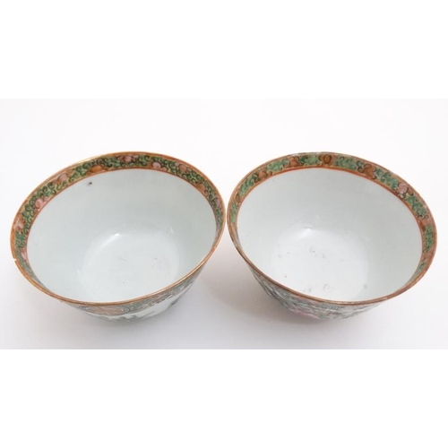 448 - A pair of Canton enamel painted bowls, one decorated with shou characters and peaches, the other wit... 