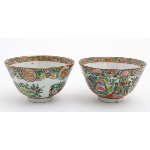 448 - A pair of Canton enamel painted bowls, one decorated with shou characters and peaches, the other wit... 