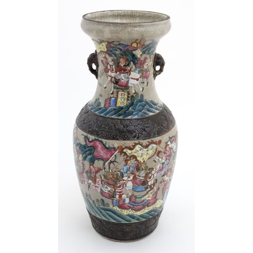 449 - A large Chinese crackle glazed two handled vase decorated with figures and horses in a mountainous l... 