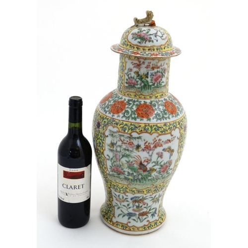 450 - A Chinese Cantonese  lidded porcelain vase , the famille rose cartouches decorated with exotic birds... 