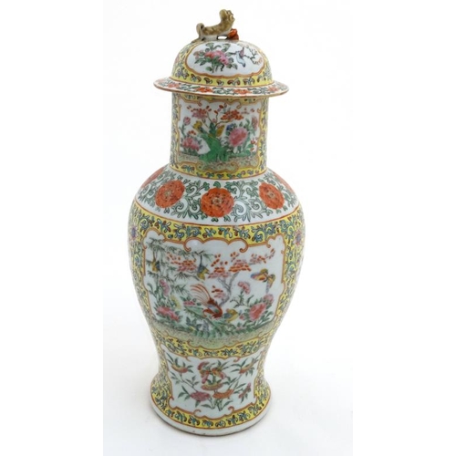 450 - A Chinese Cantonese  lidded porcelain vase , the famille rose cartouches decorated with exotic birds... 