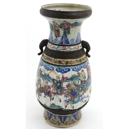 453 - A large Chinese crackle glazed two handled vase decorated with warring figures on horseback under st... 